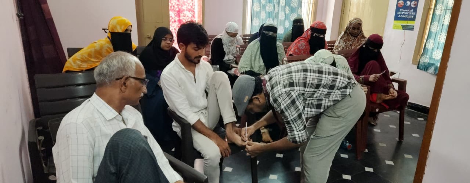 Students practising acupuncture during hands-on training
